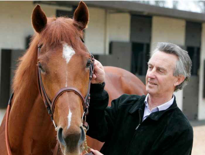 Jim Bolger stands beside horse