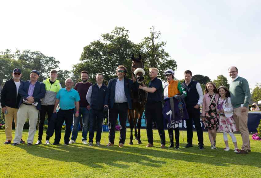 Winning connections posing for a picture at Leopardstown racecourse