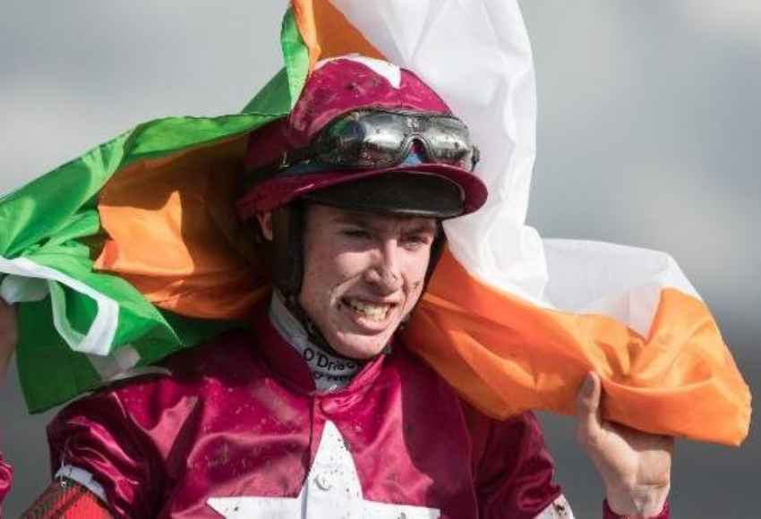 Jack Kennedy wrapping Irish flag around himself 