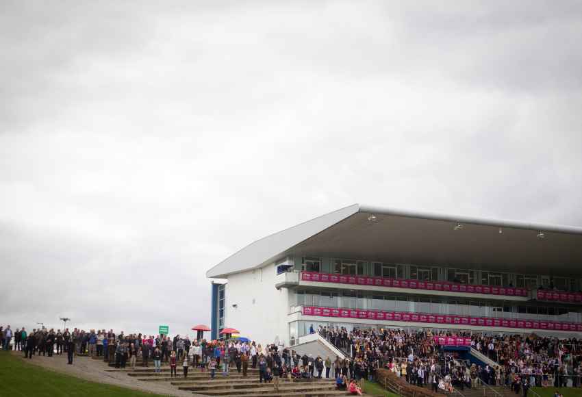 Shot from a distance of busy crowd gathering by the stands 