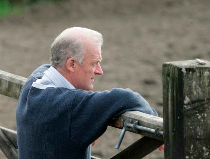 Willie Mullins leans against gate
