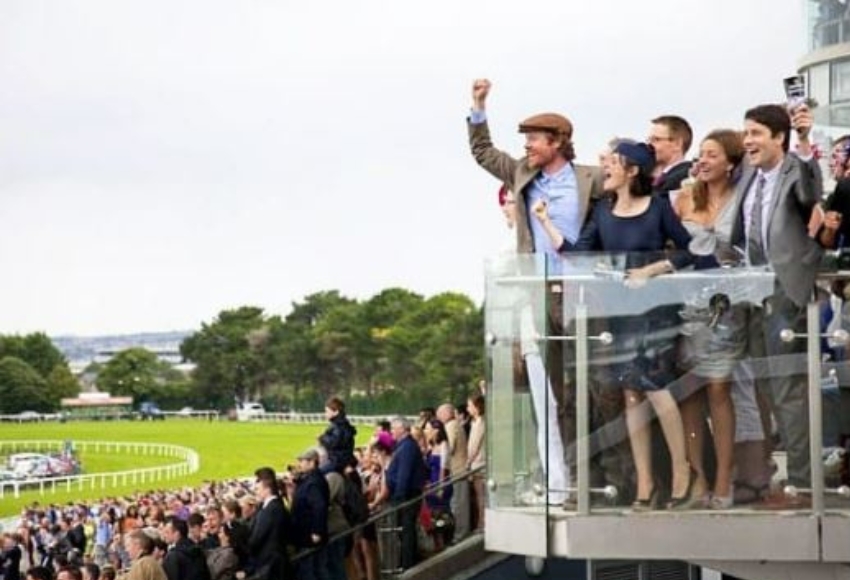 Crowd cheering on as they look out at the racetrack at Galway Summer Festival