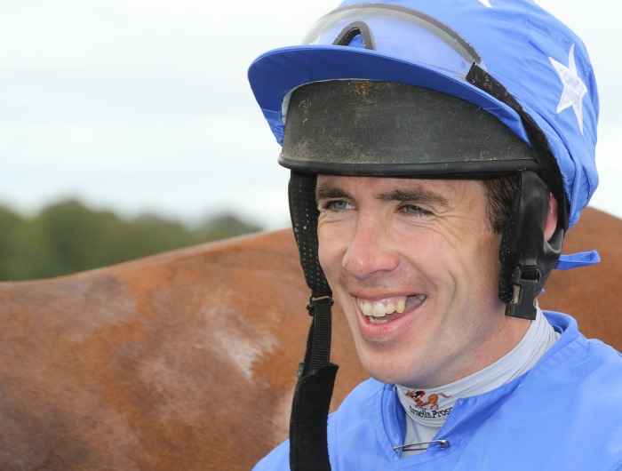 Derek O'Connor smiles with horse in background