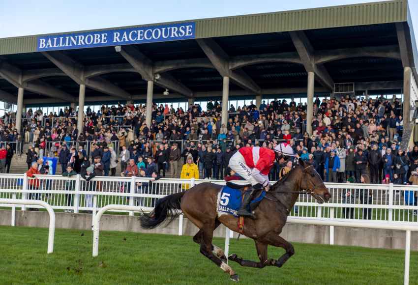 Horse running by the crowded stands at Ballinrobe races
