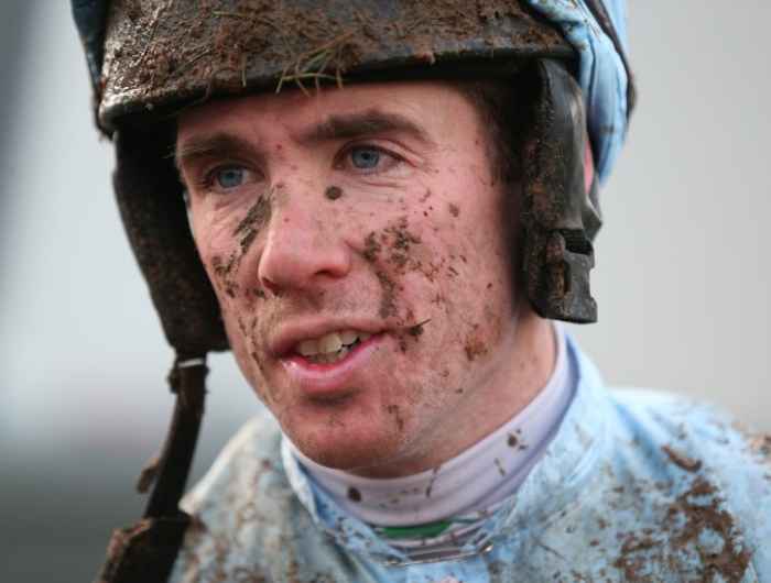 Close up of Derek O'Connor wearing jockey helmet